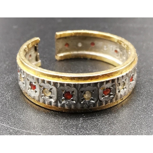 890 - A yellow metal ring (acid tests as 18ct Gold) decorated with a circle of small diamonds & rubies. Ri... 