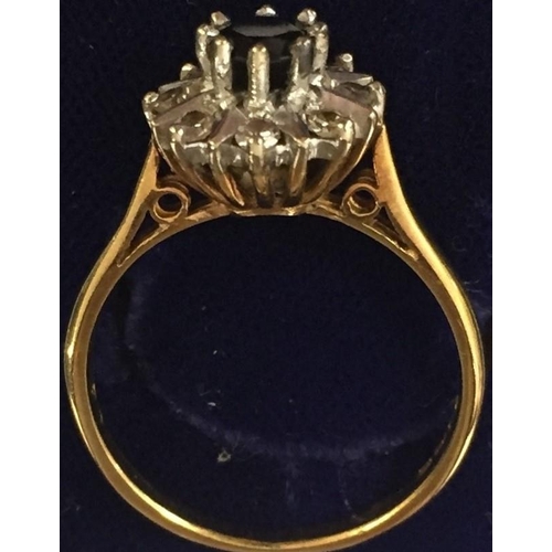 892 - A stunning 18ct Gold dress ring, with central claw set sapphire & surrounding claw set diamonds (eig... 