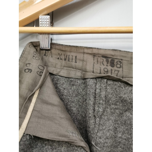 166 - A pair of WWI German Infantryman's field grey trousers, with red piping.