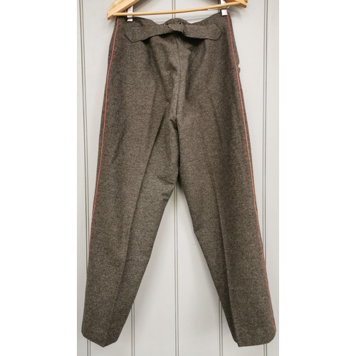 166 - A pair of WWI German Infantryman's field grey trousers, with red piping.