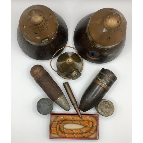 228 - A collection of mixed munitions. To include a pair of German WWI shell fuses, shells & a boxed fuse.