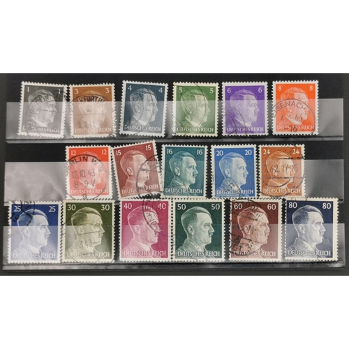 278 - A collection of thirty-six Adolf Hitler postage stamps, of various denominations, together with an e... 