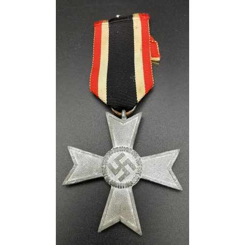 282 - A WWII German War Merit Cross & ribbon. A non-combatant example. The award was created in 1939 to re... 