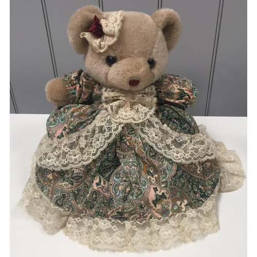 4025 - A Dutch display teddy bear, by 'L Dake & ZN', with stand & paisley pattern dress. Item no. M086.