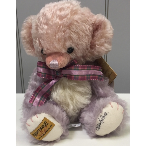 Merrythought 'Cheeky Pink/Mauve' bear. With accompanying tartan ribbon. Limited edition 6/10.  Paw personally signed by Oliver Holmes (Merrythought managing director at the time).  Complete with original tags.