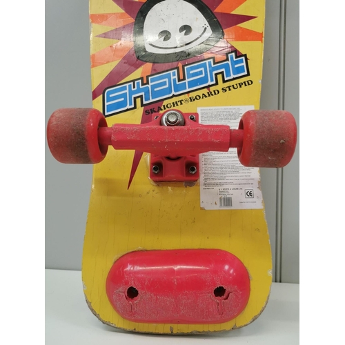 1889 - A colourful 1980's skateboard, by 'Skaight Board Stupid'. Length 77cm, width 26cm.