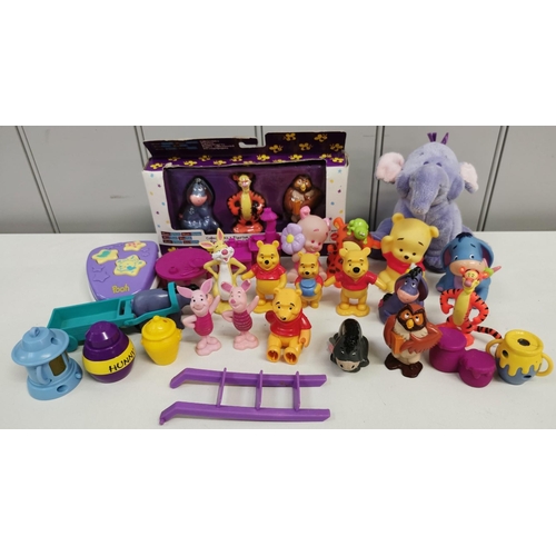 4082M - A collection of nineteen Winnie The Pooh character toys, together with accessories.