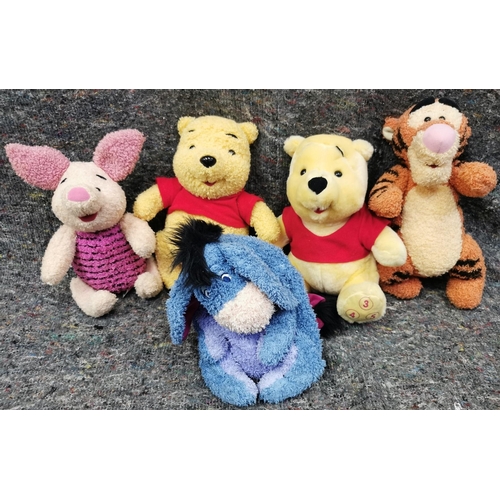 4082K - A collection of five Winnie The Pooh soft toys, four with growlers (not Eeyore).