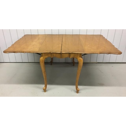 18 - A drop leaf extendable dining table, with a scalloped edge. Multi-extendable, complete with two addi... 