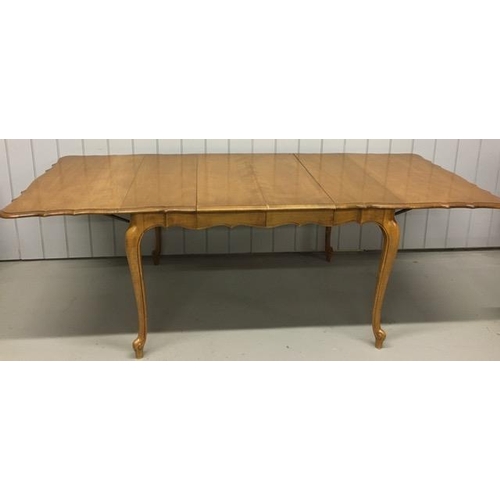 18 - A drop leaf extendable dining table, with a scalloped edge. Multi-extendable, complete with two addi... 