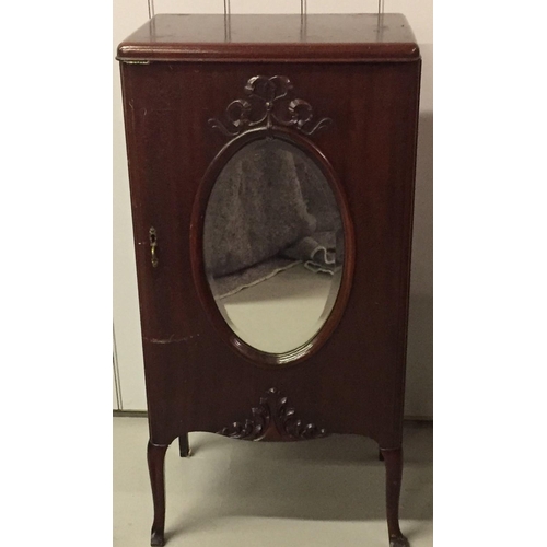 20 - A mahogany sheet music cabinet, with mirrored door detail. Dimensions(cm) H96, W48, D37.