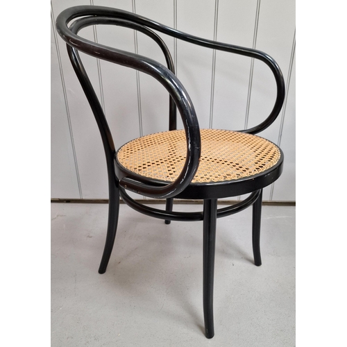 22 - A vintage, Thonet armchair. Ebony-coloured frame, with rattan seat. Made by 'ZPM Radomsko' in the 19... 