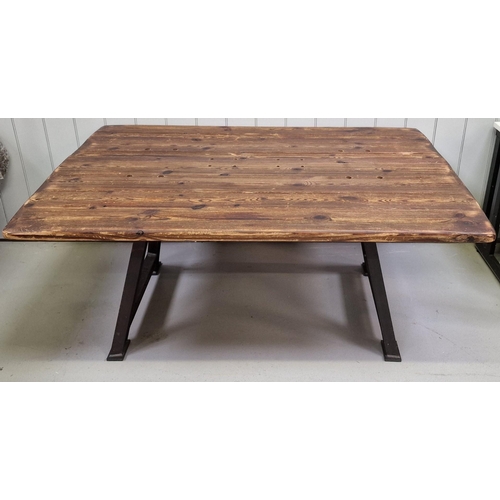 91 - An industrial-styled dining table. Rustic plank-topped, with weathered steel trestle supports. Dimen... 