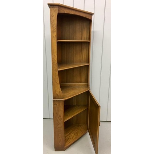 92 - An Ercol dark elm corner display unit, with twin shelves over a single shelved cupboard. Dimensions(... 