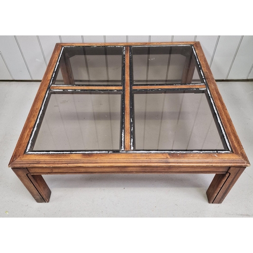 99 - A sectional glass-topped coffee table. 'Window-effect' top with four removable glass sections. Dimen... 