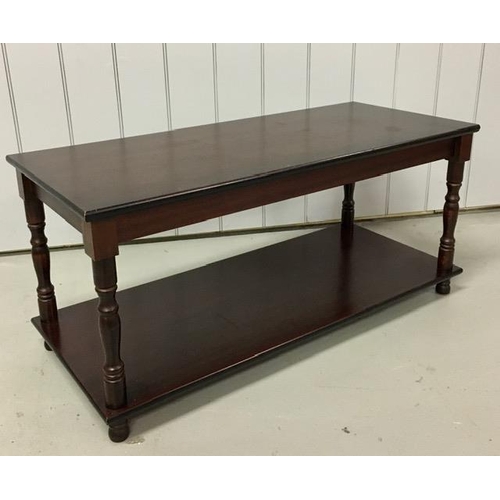 15 - A mahogany veneered coffee table. Dimensions(cm) H50, W106, D46.