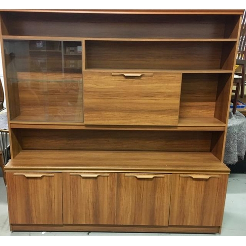 28 - A large teak display cabinet. Base features two double cupboards and would make a marvellous sideboa... 