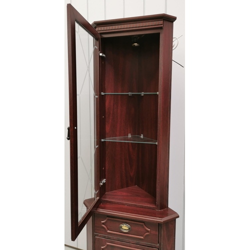 41A - A mahogany-effect corner cabinet. Glazed top with internal light & two glass shelves, over a single ... 