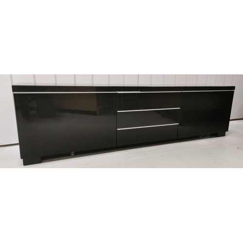 112 - A large, contemporary TV cabinet/media organiser, in gloss black. Features three fall-front central ... 