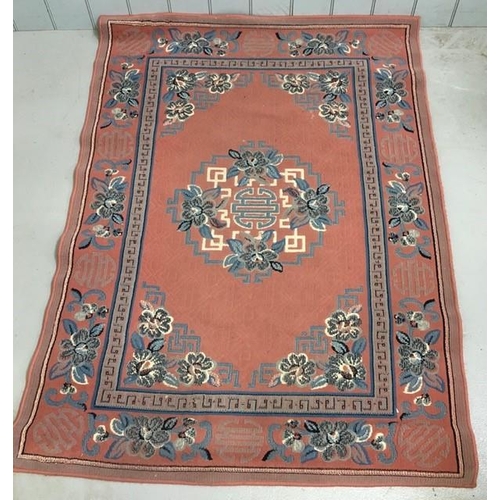 192 - A modern, man-made, pink/patterned rug. 170cm x 120cm.