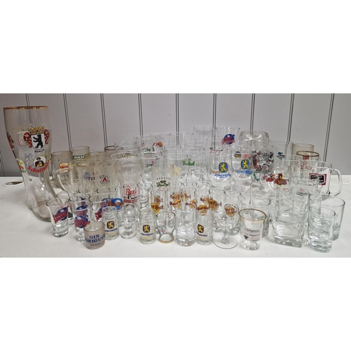 175 - A large collection of approximately one hundred branded pub glassware.