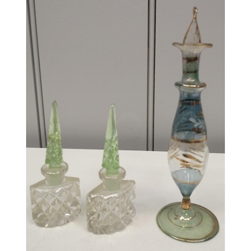 194 - Three early-mid 20th century perfume bottles. To include a likely Egyptian example. Tallest 15cm.