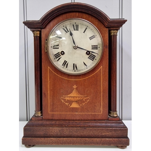 389 - An Edwardian mahogany inlaid mantle clock, with a brass bezel, circular dial, original hands & pilas... 