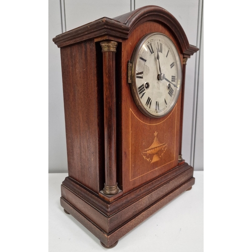 389 - An Edwardian mahogany inlaid mantle clock, with a brass bezel, circular dial, original hands & pilas... 