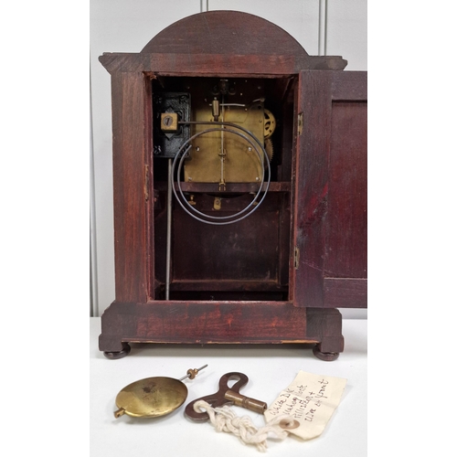 389 - An Edwardian mahogany inlaid mantle clock, with a brass bezel, circular dial, original hands & pilas... 