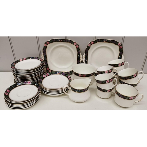 406 - A pretty 'Grafton China' tea set in white, with black, floral & bird border design. Forty-three piec... 