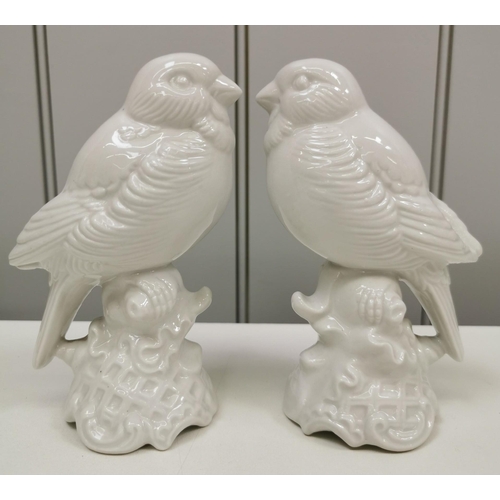 413 - A pair of Dresden white, glazed porcelain bird figures. Dimensions(cm) H15, W10, D6.