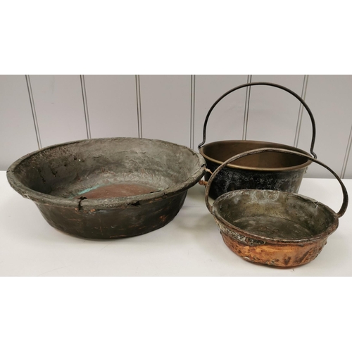 428 - A collection of three antique copper pans. Diameters 40cm/18cm/12cm.