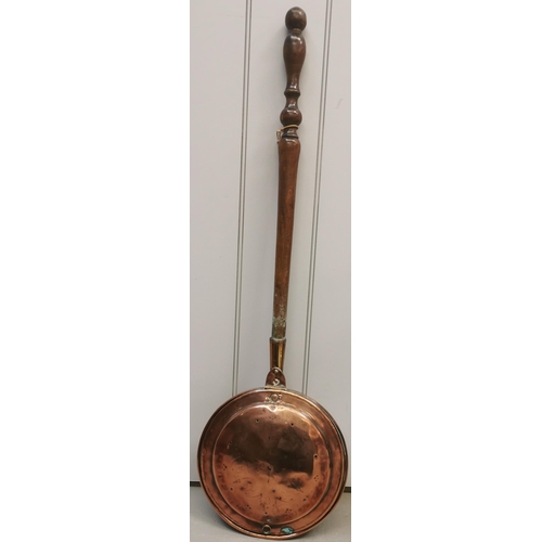 430 - A vintage, copper bed warmer with turned handle. Length 101cm.