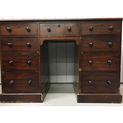 74 - A vintage, mahogany kneehole desk, with two banks of four graduated drawers & a single central drawe... 