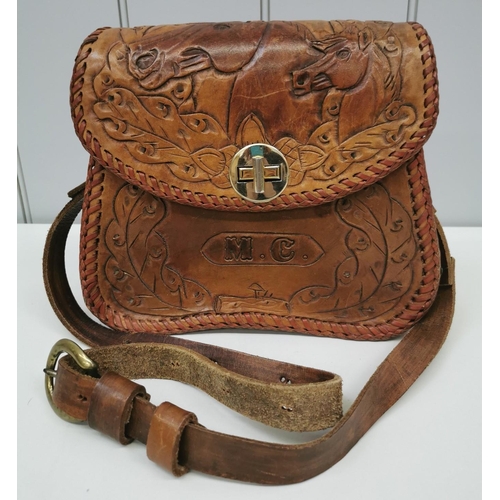 1435 - A vintage brown leather shoulder bag with carved detail, engraved 'M.C.', with horses & leaves. Dime... 