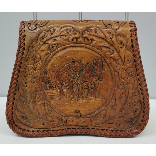 1435 - A vintage brown leather shoulder bag with carved detail, engraved 'M.C.', with horses & leaves. Dime... 