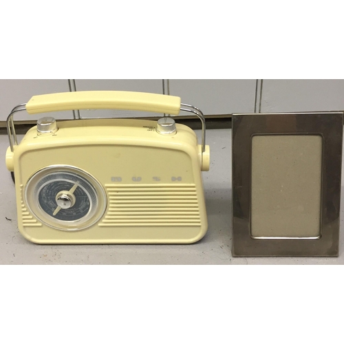 1594 - A retro-style electronic radio, by 'Bush'. Model no. JN-7024. Together with a silver-plated photo fr... 