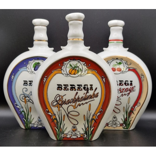 1103 - A trio of Hungarian ceramic liqueur flasks 'Beregi'. Height 20cm.