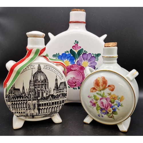 1104 - A mixed trio of traditional Hungarian ceramic liqueur flasks. Heights 20cm/16cm/14cm.