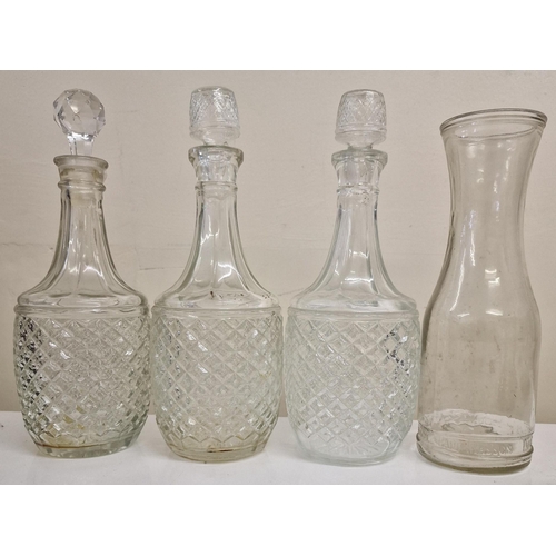 240 - A selection of vintage glass tableware. To include three decanters , a set of four wine glasses with... 