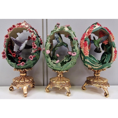 462 - A collection of seven 'House of Faberge' decorated & plinthed, bird-enclosed eggs