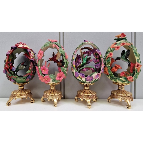 462 - A collection of seven 'House of Faberge' decorated & plinthed, bird-enclosed eggs