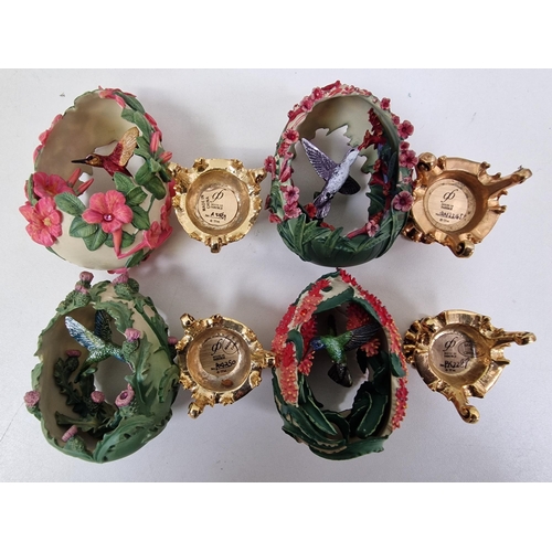 462 - A collection of seven 'House of Faberge' decorated & plinthed, bird-enclosed eggs