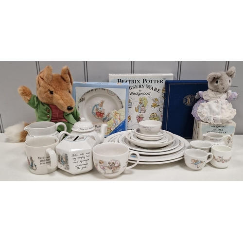 A collection of twenty-six branded Beatrix Potter items. To include boxed Wedgwood examples, moneybox soft toys etc.