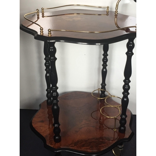 2 - A vintage Italian Bar Cart. Two lacquered tiers, with brass fittings/castors & ebonised supports. Di... 