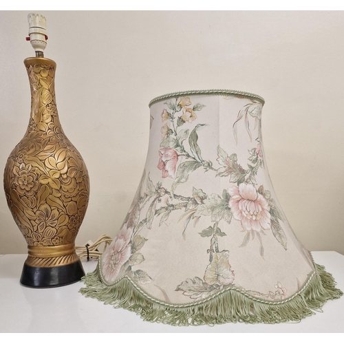 61 - A vintage table lamp, with a gold-coloured floral design. Complete with shade. PAT test pass & funct... 