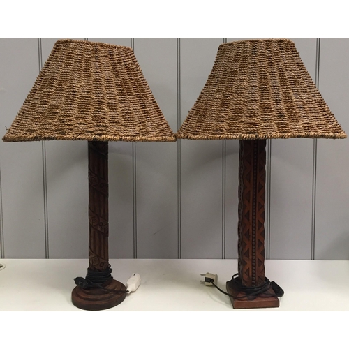 62 - A pair of mid-century, carved wooden table lamps, with rattan shades (differently shaped). Will requ... 