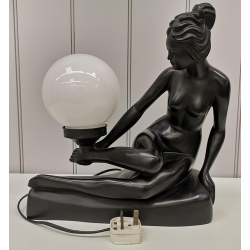 79 - A figural table lamp. Features a reclining lady with large orb lamp. PAT Test pass & functionality t... 