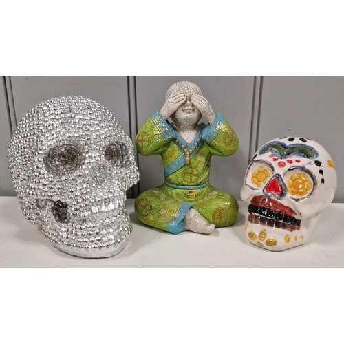 94 - A mixed lot of contemporary decorative pieces. To include two skulls & a Buddha figurine. Tallest 15... 