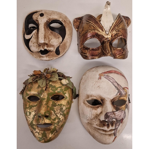 103 - A collection of four Venetian-style face masks.